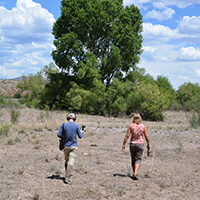 Rosdail and Martha Cooper walking along the Gila River floodplain near Iron Bridge. Photo Credits: Mary Harner